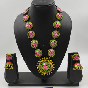 Jewelry set with necklace and earrings on a black mannequin bust against a white background